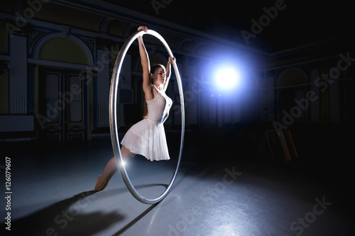 Professional circus performer rotate on cyr wheel photo