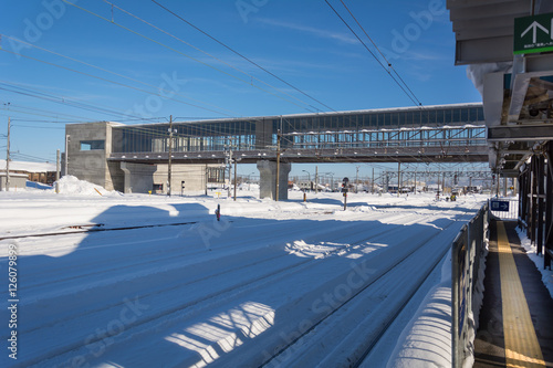Fototapeta Naklejka Na Ścianę i Meble -  Snow on railway station with blue sky in Japan.