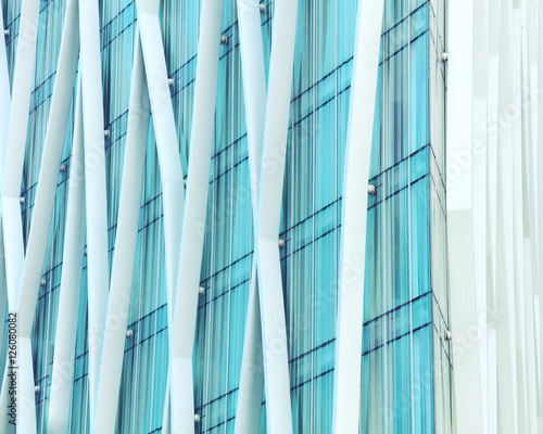 Abstract fragment of modern glazed facade with white vertical stripes