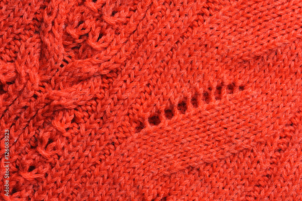 Closeup of knitted ornament on woolen texture