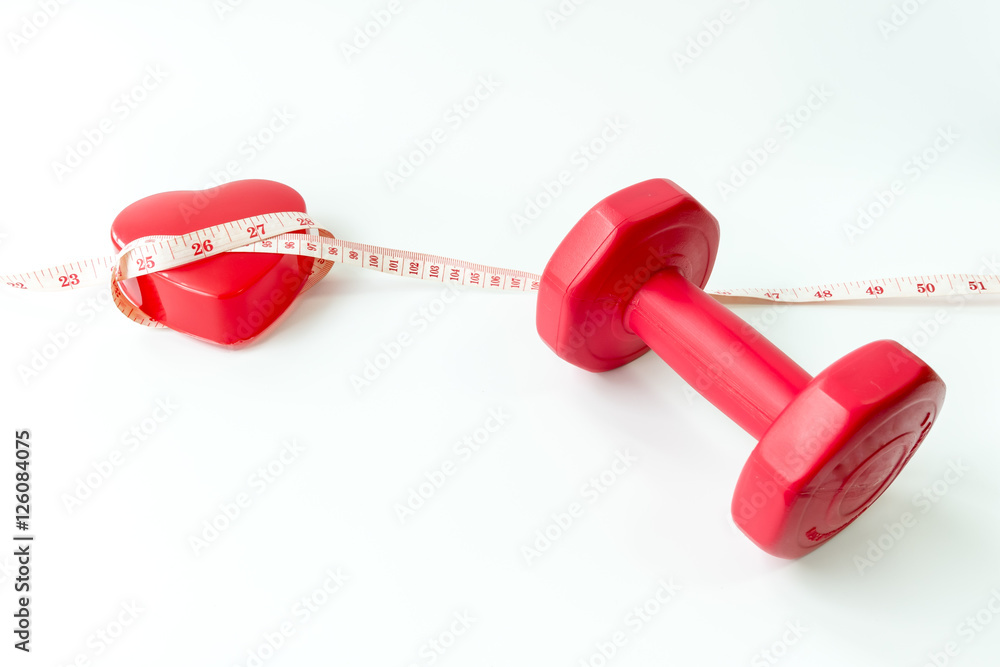 Healthy lifestyle to protect heart disease concept. Closeup red dumbbells with measuring tape around red heart. Healthy lifestyle to protect heart disease concept. Closeup red dumbbells with measuring tape around red heart.