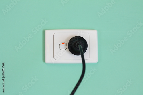Australian electricity wall socket and plug illustrating expensive power, green energy and bill shock.