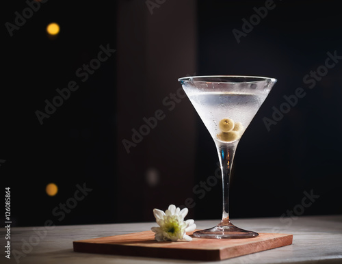Martini cocktail drink on black background.
