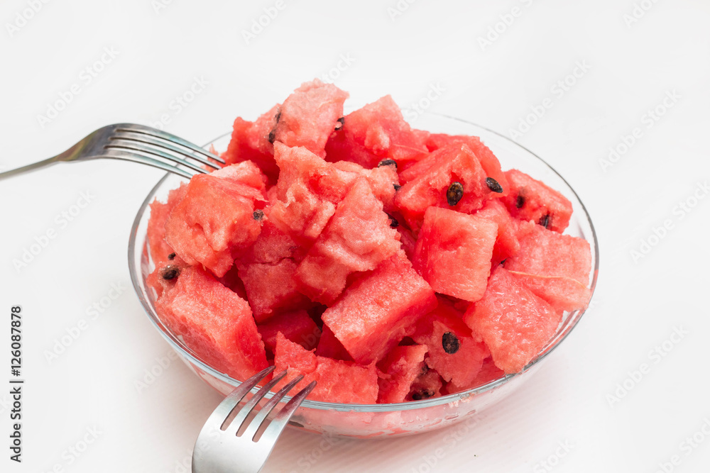 watermelon pieces in bowl with fork on white background watermelon pieces in bowl with fork on white background