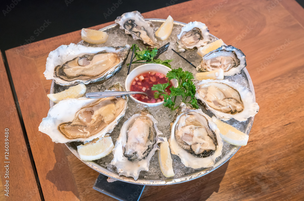 Fresh oysters on ice with lemon
Fresh oysters on ice with lemon