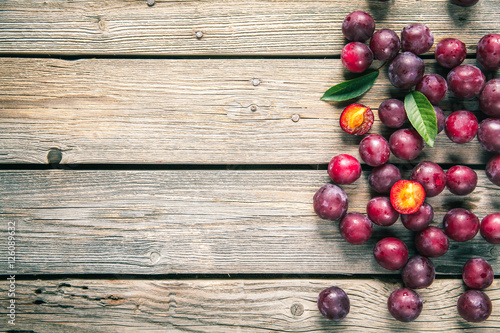 fresh plums on wooden table