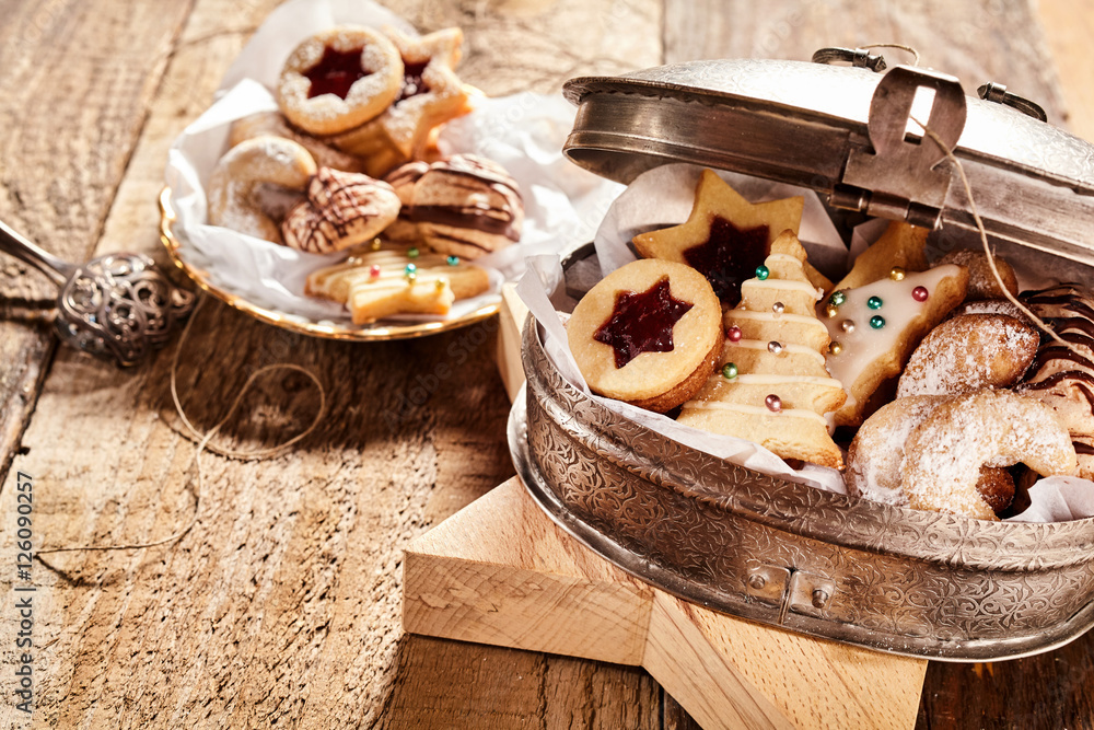 Fototapeta premium Half open cookie container over wood background