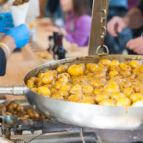 New potatoes fried in a pan with Italian recipe: potatoes salent photo