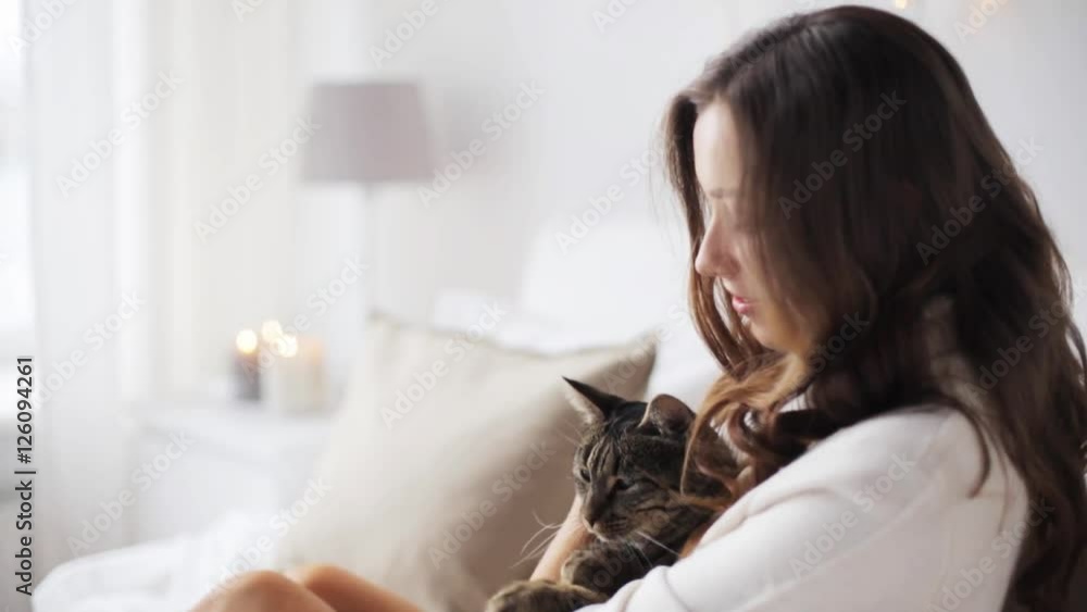 happy young woman with cat in bed at home happy young woman with cat in bed at home