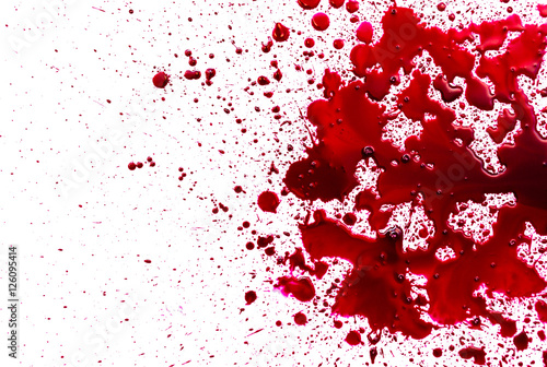 Splattered blood stain on white background photo