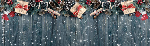 Christmas background with spruce, gift box, Santa Claus boots an