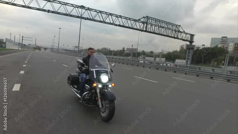 Biker Rides on Classic Motocyle on the Highway Biker Rides on Classic Motocyle on the Highway