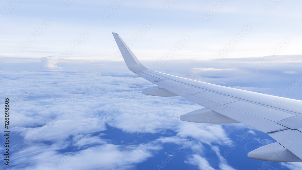 Wing of airplane fly over the blue sky and white cloud 1 Wing of airplane fly over the blue sky and white cloud 1