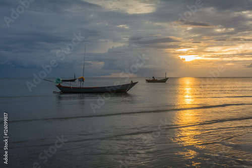 Fishing boats in the sea and a beautiful sky while the sunset, Chao Lao Beach, Chanthaburi, Thailand.
