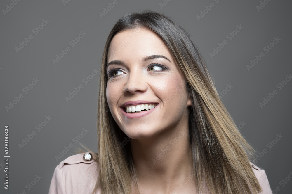 Happy gorgeous young woman looking away with white toothy smile Happy gorgeous young woman looking away with white toothy smile