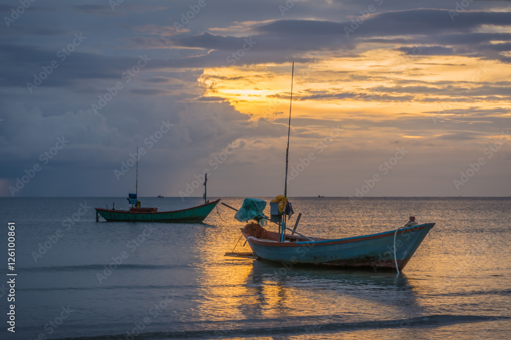 Fishing boats in the sea and a beautiful sky while the sunset,  Chao Lao Beach,  Chanthaburi, Thailand.