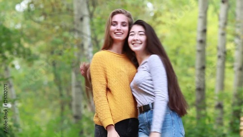 Two beautiful girl with long hair plush in nature