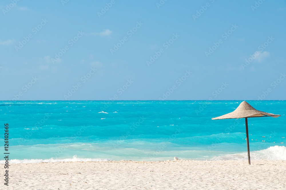 parasol on a tropical azure beach