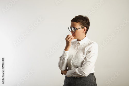 Cuadro en lienzo Teacher in conservative white and grey outfit and round black glasses deep in th