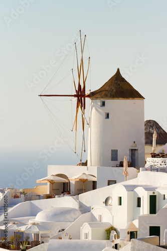 Famous windmill in Oia, Santorini at daylight. Vertical shot