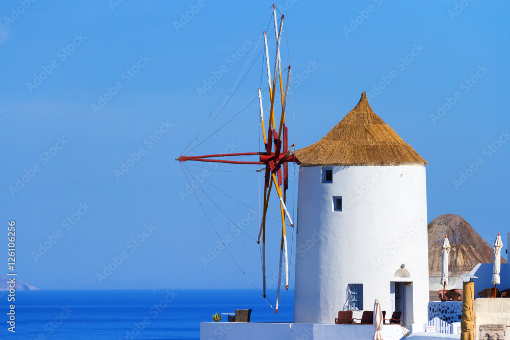 Famous windmill in Oia, Santorini shot in the morning at sunrise