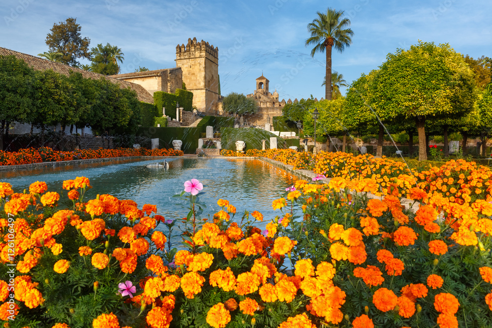 Blooming gardens and fountains of Alcazar de los Reyes Cristianos, royal palace of the cristian kings, in Cordoba, Andalusia, Spain - obrazy, fototapety, plakaty 