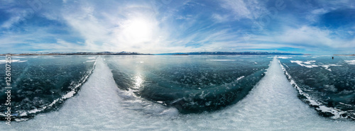 cylindrical panorama 360 a big white cracks on the ice of Lake B photo