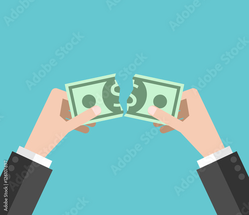 Hands tearing dollar