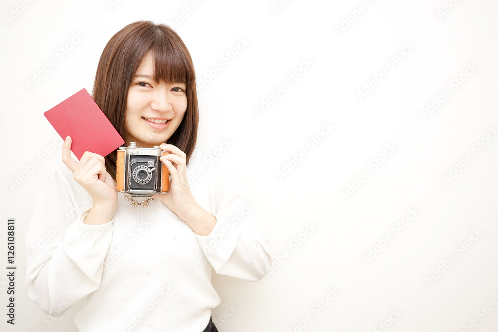 Young woman holding her passport with smile