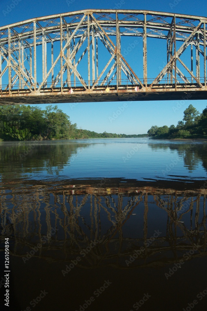 Obraz premium ..Railway bridge over the river. Bug valley. View of the metal structure of the river.