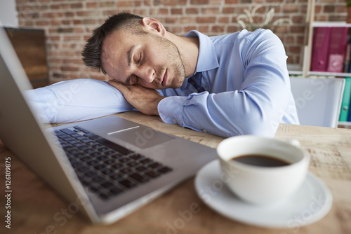 Man sleeping on the office desk