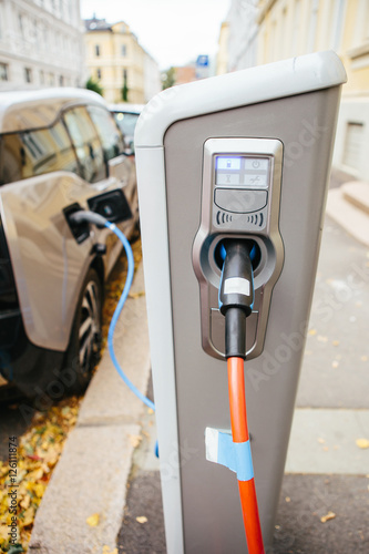 Vehicle with an electric motor. Electric vehicle charging. Eco car.
