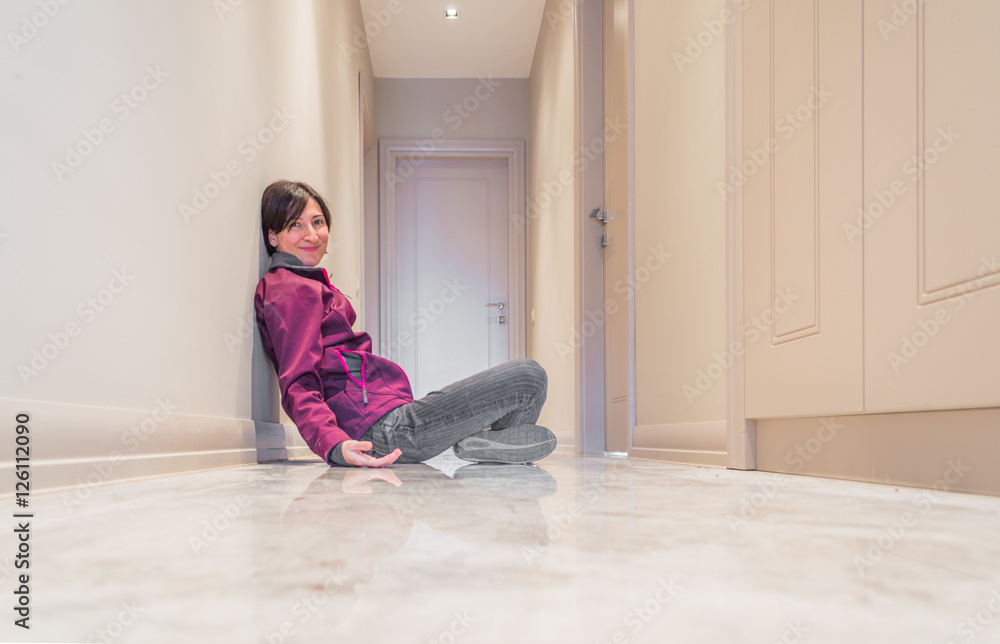 Smiling Woman Sitting on the Floor Alone