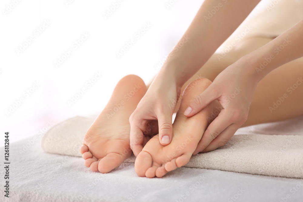 Foot massage in spa salon, closeup