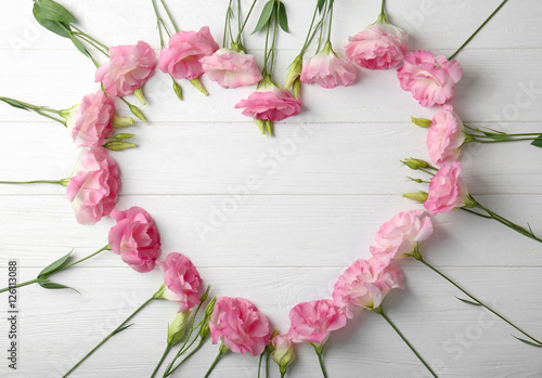Fototapeta Naklejka Na Ścianę i Meble -  Fresh pink flowers frame on wooden background