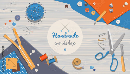 Sewing workshop or studio. In the workplace, tools and cloth on a gray wooden desk.