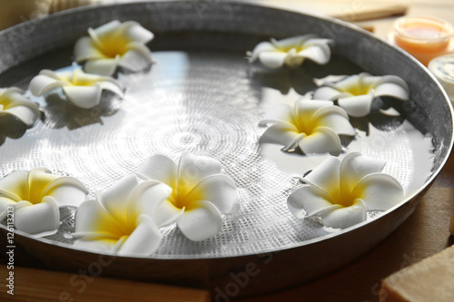 Exotic flowers in bowl with clear water
