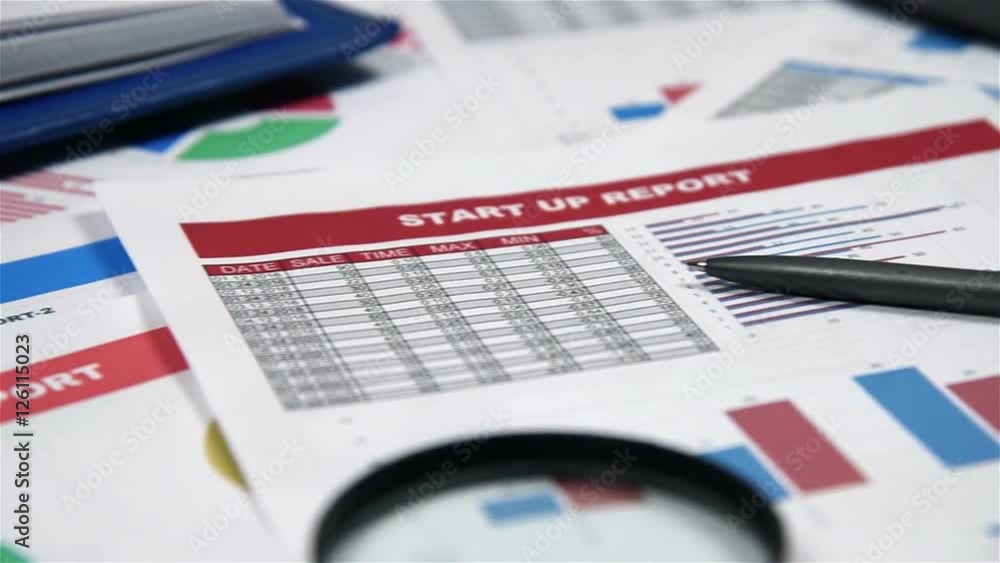 Office Desktop With Business Items, Stock Exchange Statistics, Pen, Calculator And Red Glasses Office Desktop With Business Items, Stock Exchange Statistics, Pen, Calculator And Red Glasses