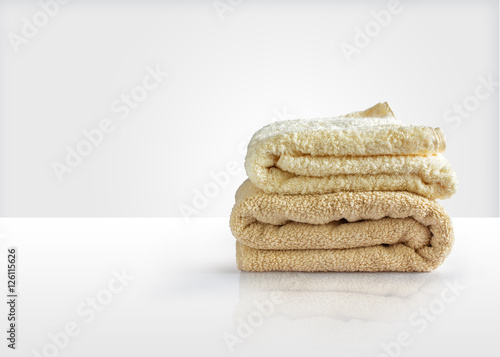 Wash towels on a white table, symbolizes the Laundry