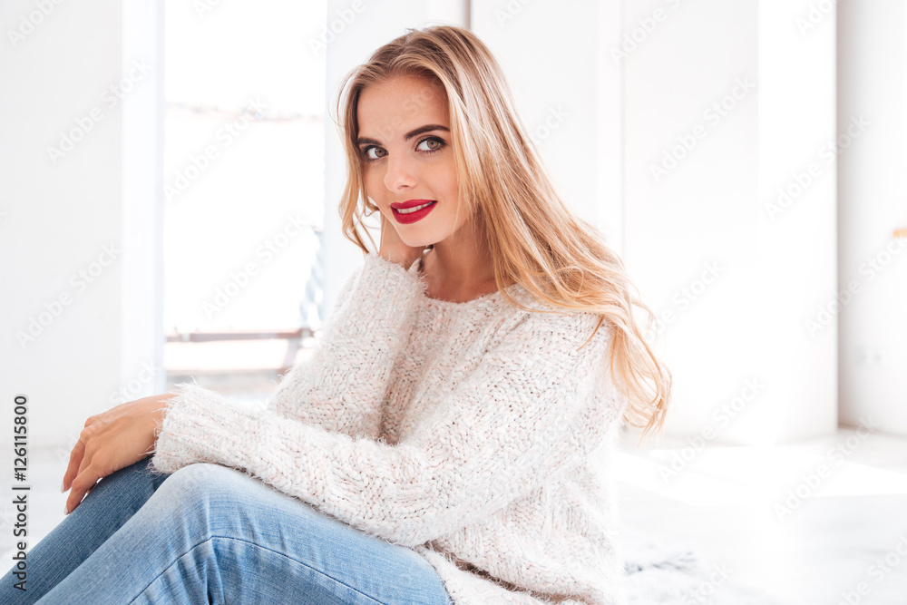 Portrait of a charming girl wearing sweater and red lipstick