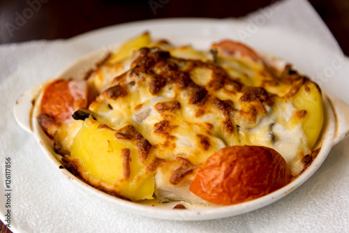 Potatoes with tomatoes baked with cheese