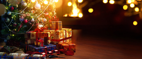 Christmas tree and holidays present on fireplace background