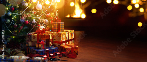 Christmas tree and holidays present on fireplace background