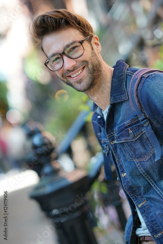 Cheerful man walking in the street, NYC tour