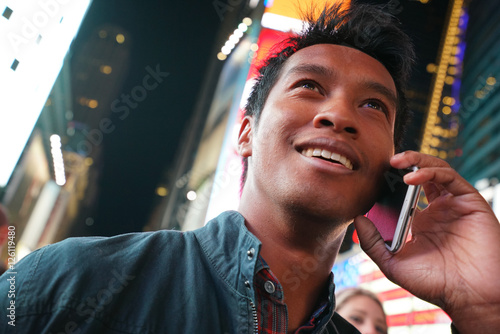 Portrait of man talking on phone at Times Square