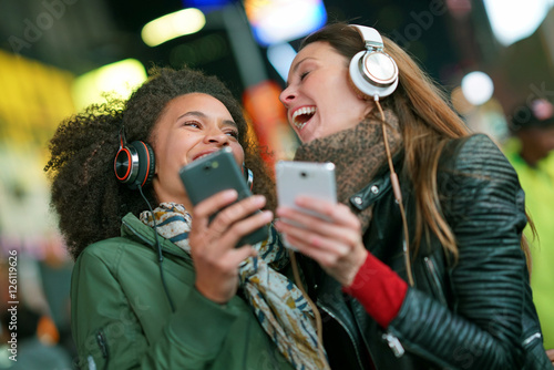 Girls listening to music with smartphone