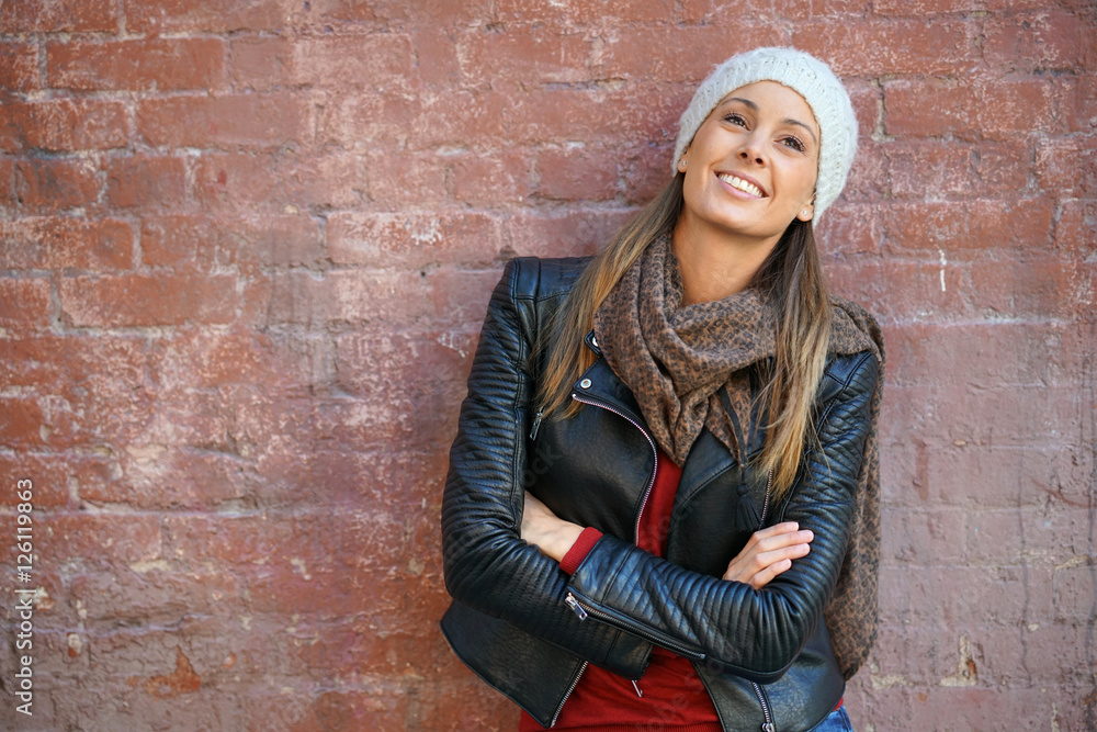 Beautiful woman leaning on brick wall, isolated Beautiful woman leaning on brick wall, isolated