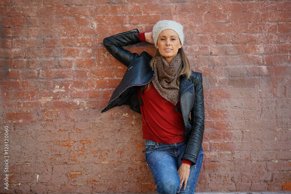 Beautiful woman leaning on brick wall, isolated Beautiful woman leaning on brick wall, isolated