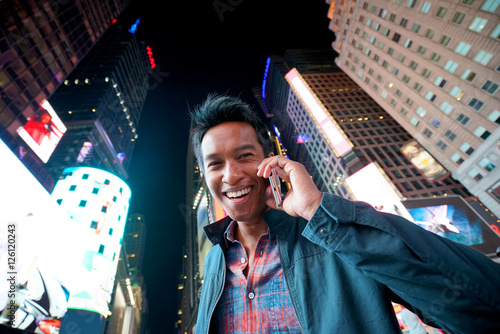 Portrait of man talking on phone at Times Square