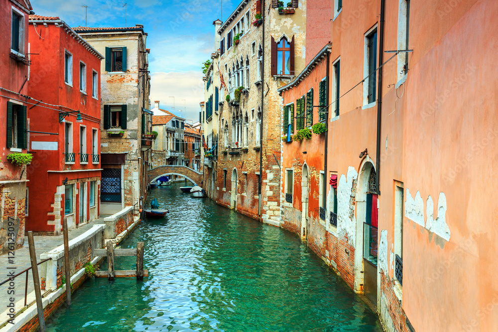 Narrow canal with boats in Venice,Italy,Europe